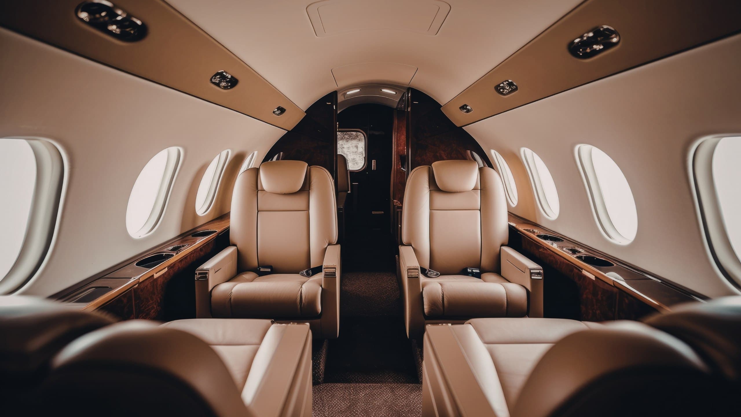Luxury private jet interior with leather seating and warm golden cabin light
